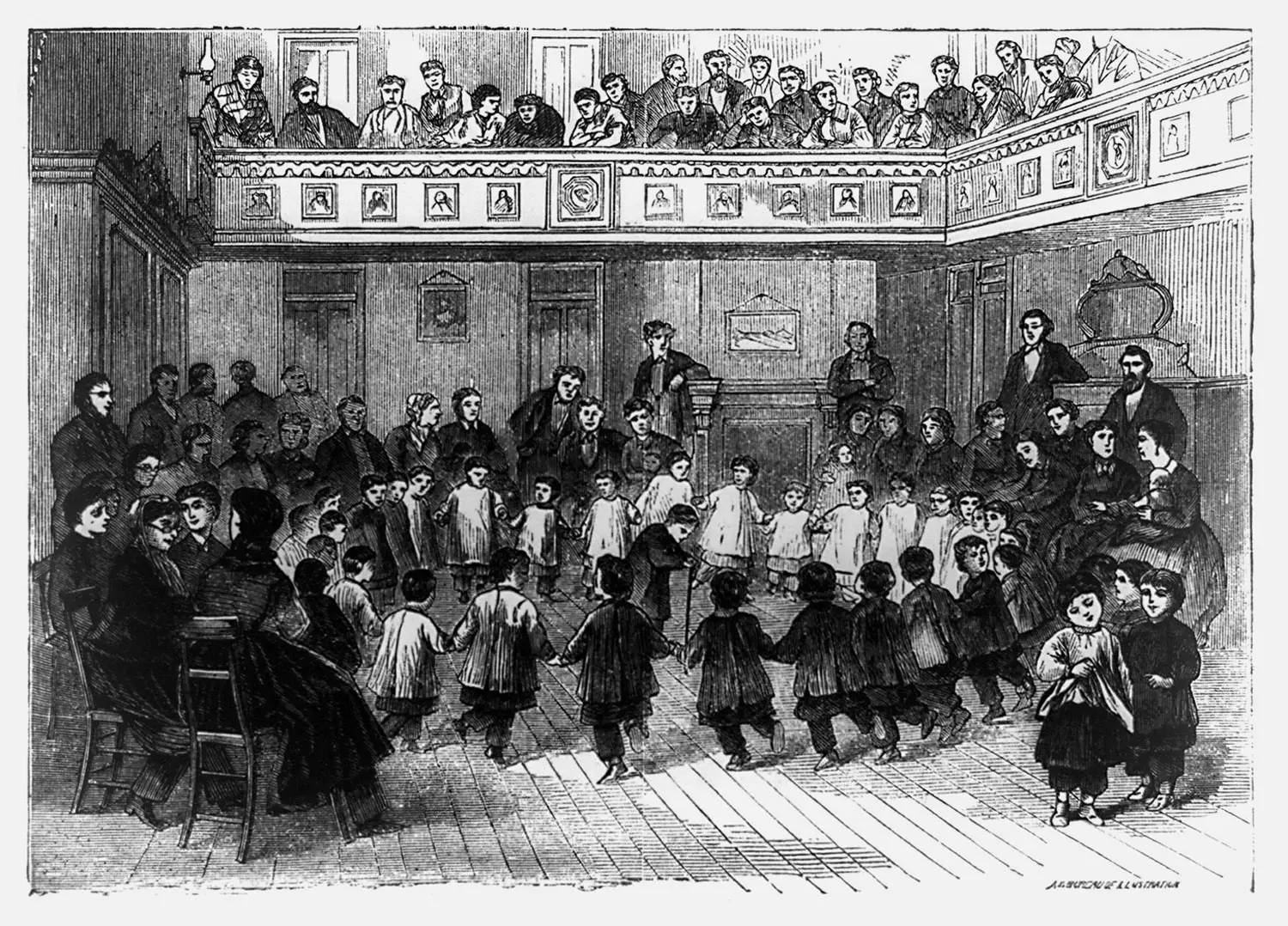 A group of children dance in a circle while adults around them, and in the balcony above, look on.