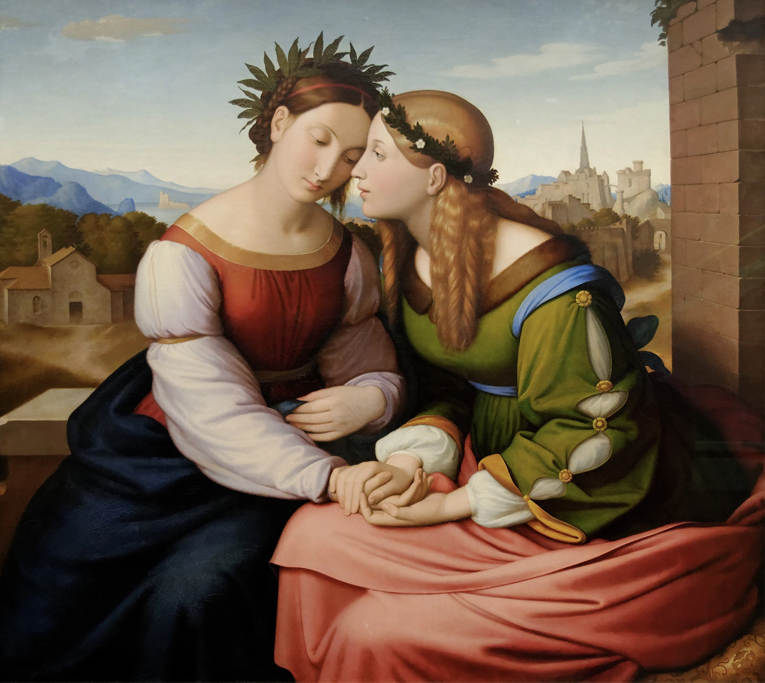 An intimate scene of two women, presumably representing Italy and Germany, who are sitting closely together, holding hands and leaning towards each other.