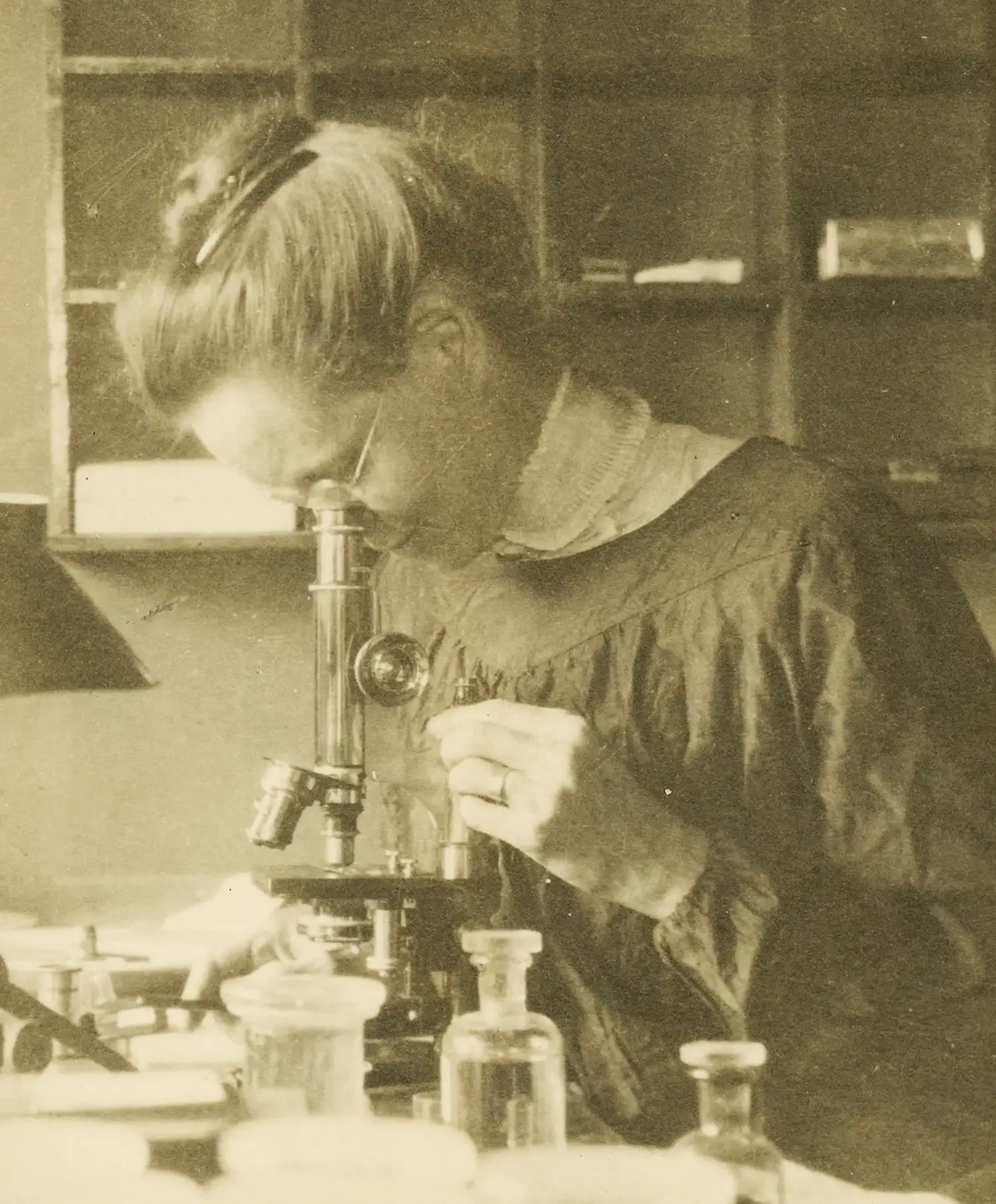 Nettie Stevens looks into a microscope.
