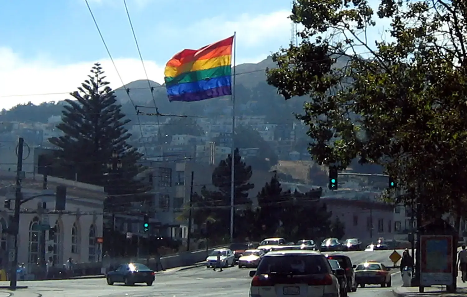 A queer flag rises above the Castro neighborhood.