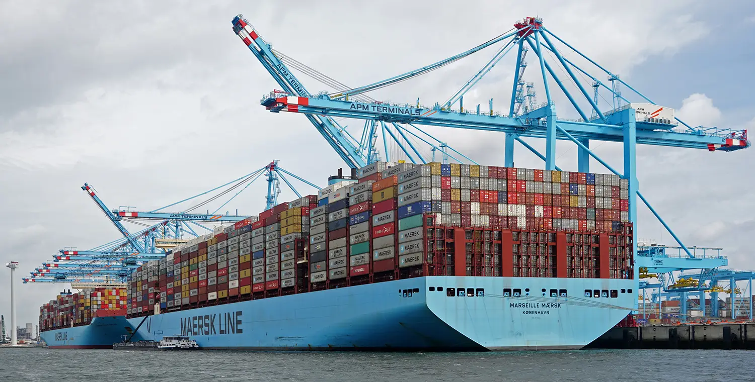 Two large container ships stacked with thousands of containers.