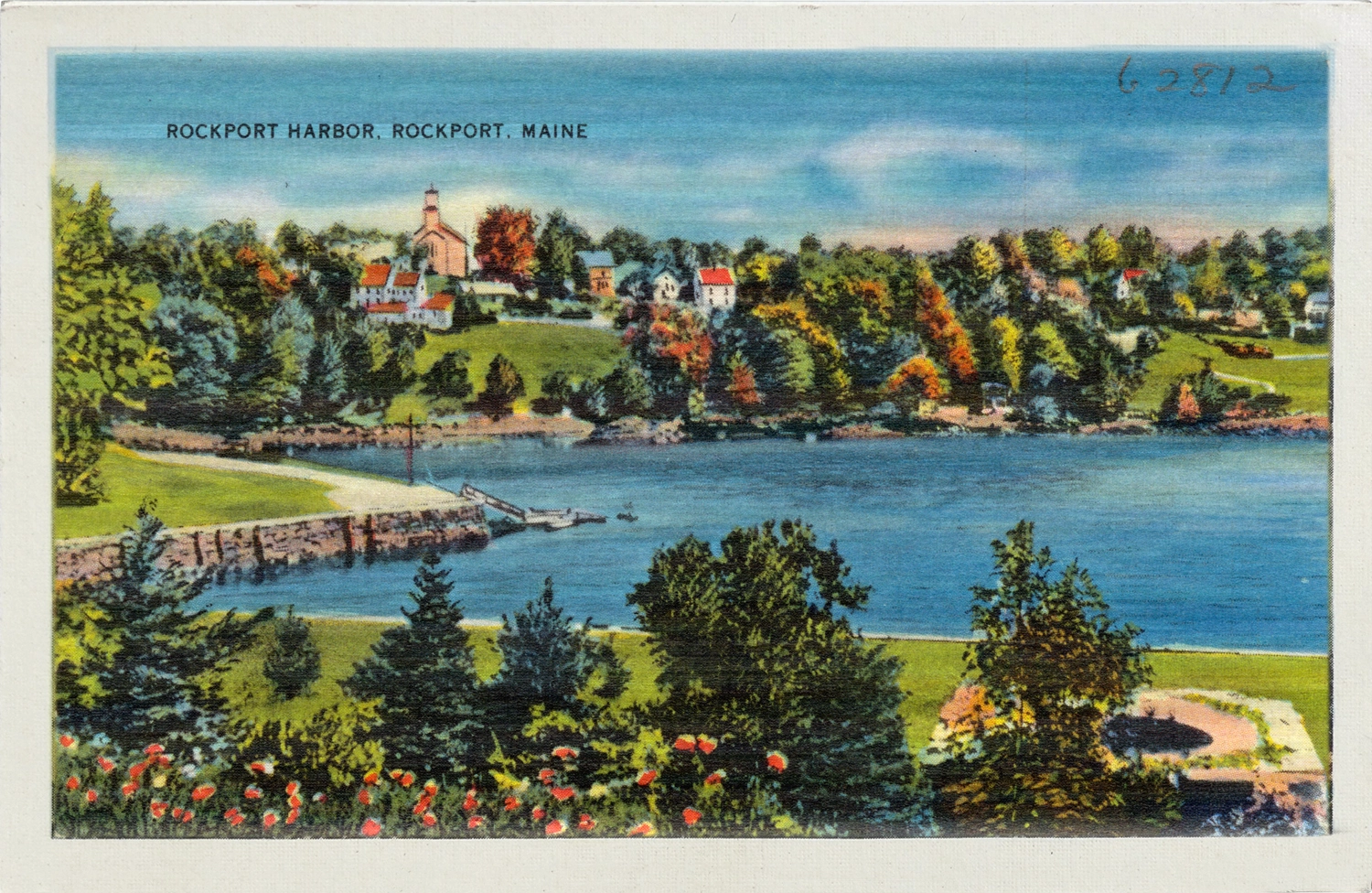 Idyllic scene of a village perched on a hill overlooking a calm harbor.